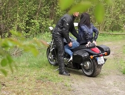 Muscled Biker Stretches Brunette'_s pussy outdoors